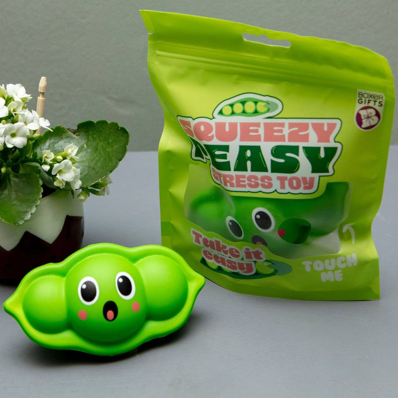 Green pea pod stress ball toy with cute face next to packaging