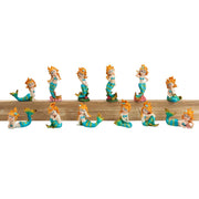 Collection of twelve small mermaid figurines with orange hair and teal tails in various poses