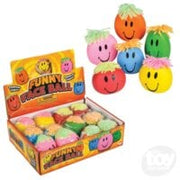 Colorful squishy pumpkin-shaped toys with smiling faces displayed with retail packaging box
