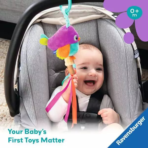 Baby in car seat playing with colorful bird toy with ribbons and hanging attachment