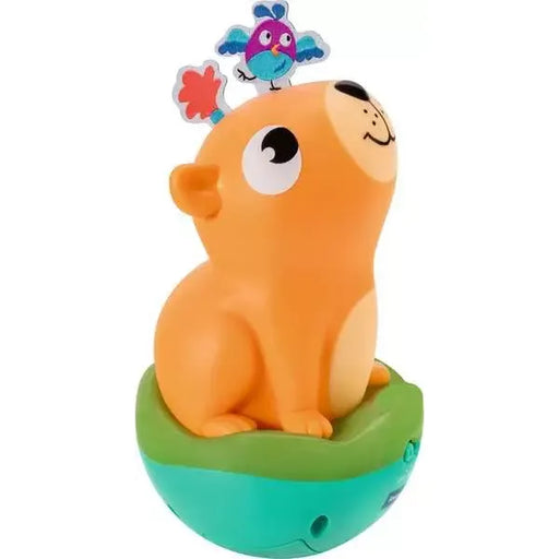 Orange capybara roly poly toy with bird on top and green base