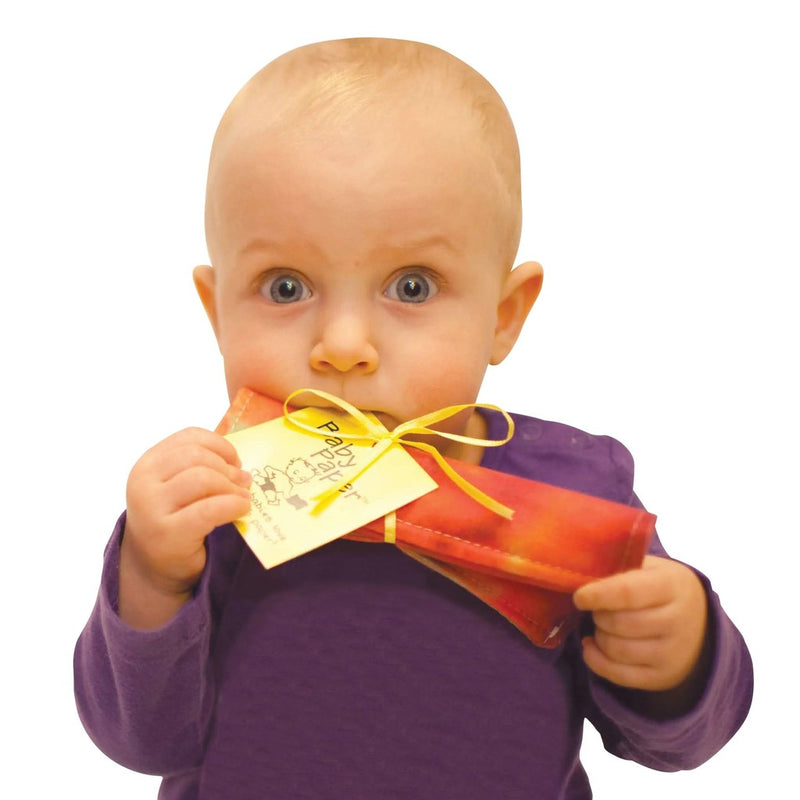 Baby holding and chewing on colorful crinkly Baby Paper toy with yellow ribbon