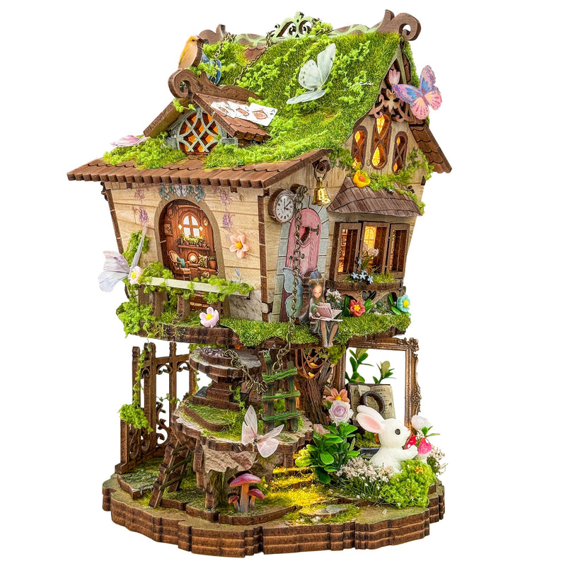 Detailed fairytale tree house miniature model with moss roof, butterflies, and white rabbit