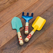 Three colorful kids garden hand tools with wooden handles on wood floor