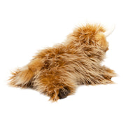 Brown highland cow plush toy with long fluffy fur on white background
