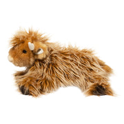 Brown Highland cow plush toy with long shaggy fur and horns on white background