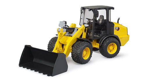Yellow CAT wheel loader toy with black bucket on white background