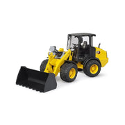 Yellow CAT wheel loader toy with black bucket on white background