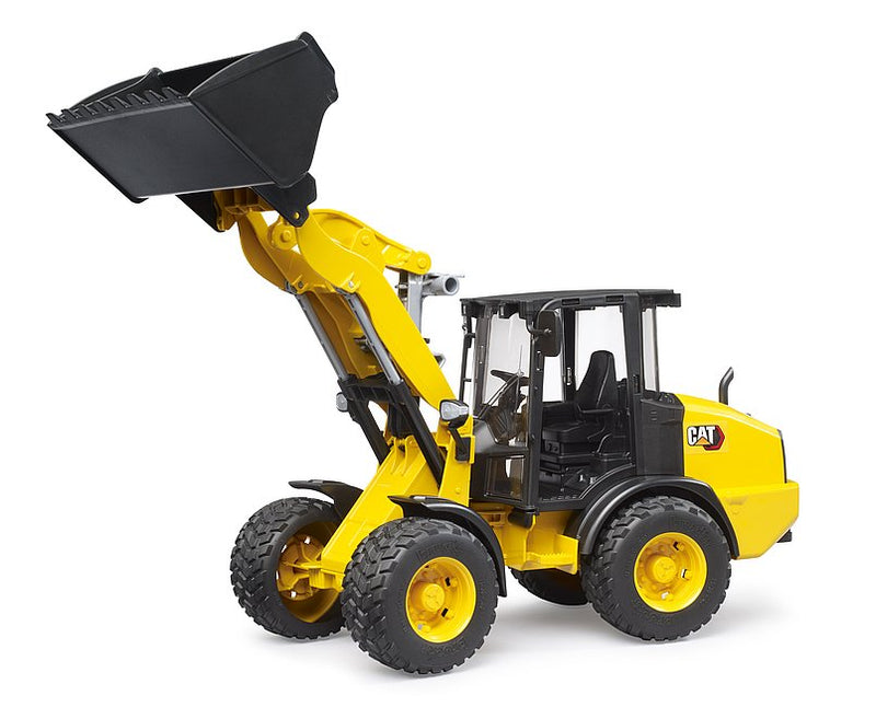 Yellow CAT wheel loader toy by Bruder on white background