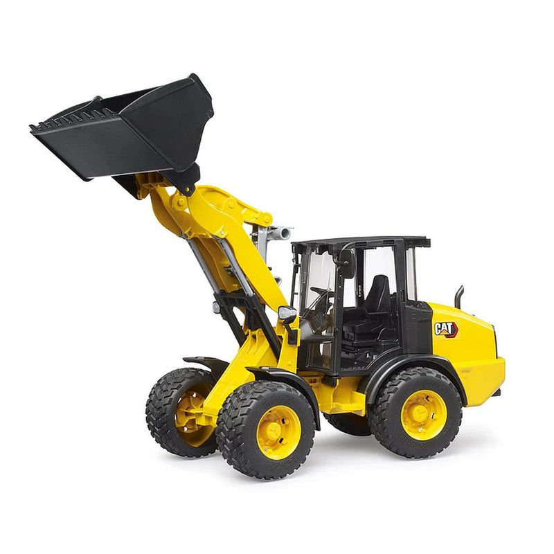 Yellow CAT wheel loader toy by Bruder on white background