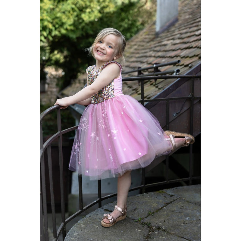 Young girl wearing pink sequined dress with tulle skirt and star decorations