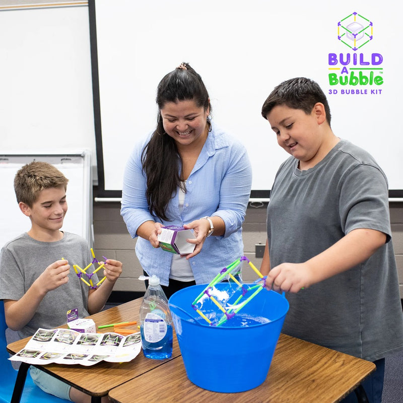 Children using Build-A-Bubble 3D bubble kit in classroom setting with teacher supervision