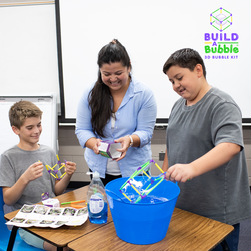 Children using Build-A-Bubble 3D bubble kit in classroom setting with teacher supervision