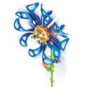 Blue wind-powered spinning flower toy with colorful center on green stem