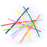 Colorful plastic tubes in various colors arranged in a starburst pattern on white background