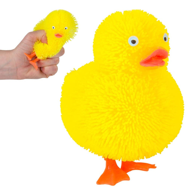 Yellow fuzzy rubber duck squishy toy with orange beak and feet, hand holding smaller version