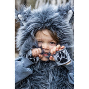 Child wearing gray furry wolf costume with hood and paw print gloves