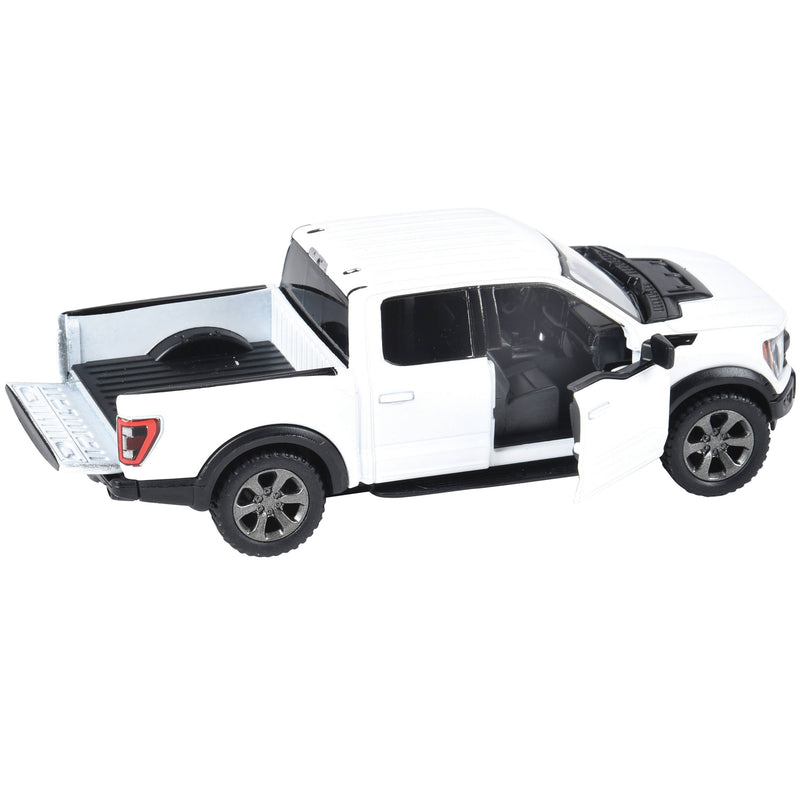 White diecast Ford F-150 Raptor pickup truck toy with open doors and tailgate