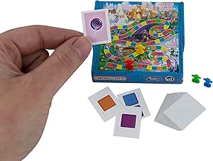 World's Smallest Candyland board game with hand showing miniature game pieces and board