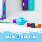 Blue bath brush with colorful bath bomb tablets on white background