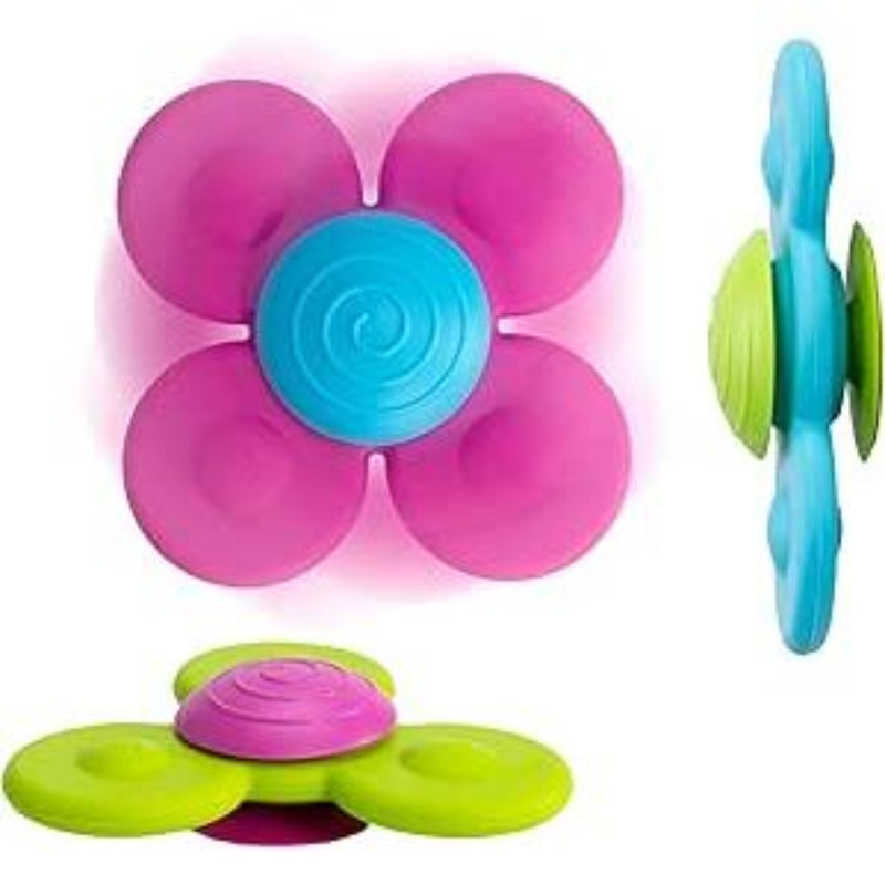 Colorful spinning suction cup toys with flower-like petals in pink, blue and green