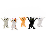 Five colorful dancing cat figurines with raised arms on white background