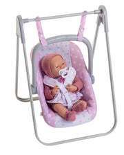 Berenguer Boutique baby doll in pink polka-dot carrier seat on gray metal swing stand