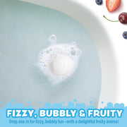 Bath bomb fizzing in bathtub with bubbles and fruit decorations around edge