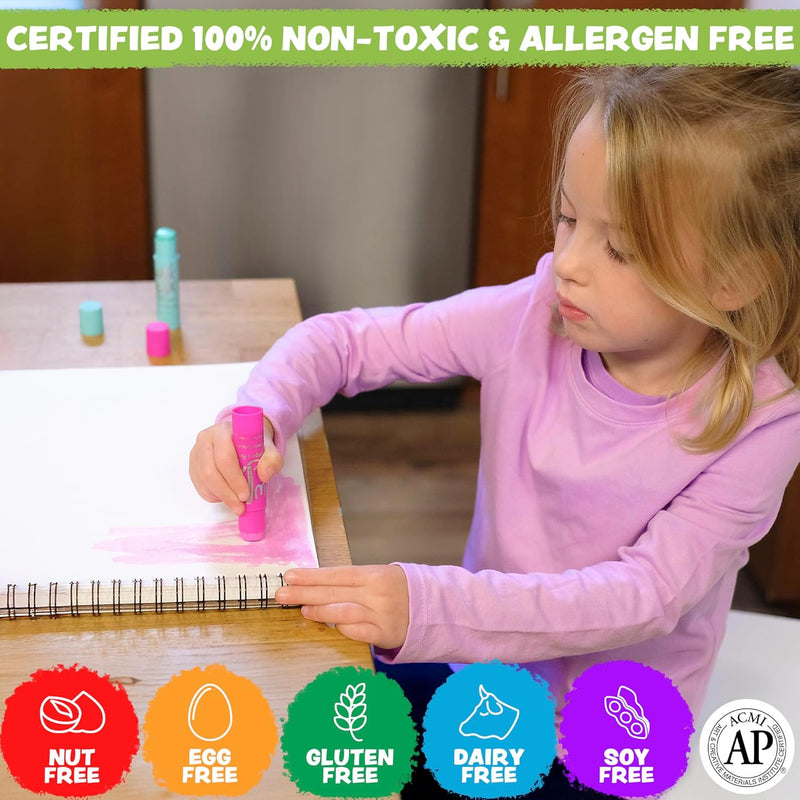 Child using colorful Kwik Stix paint sticks on paper at table