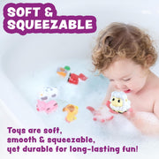 Child playing with colorful soft squeezable barnyard bath toys in bathtub with bubbles