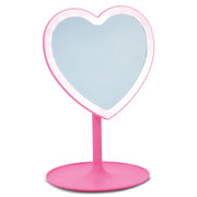 Pink heart-shaped vanity mirror with stand on white background