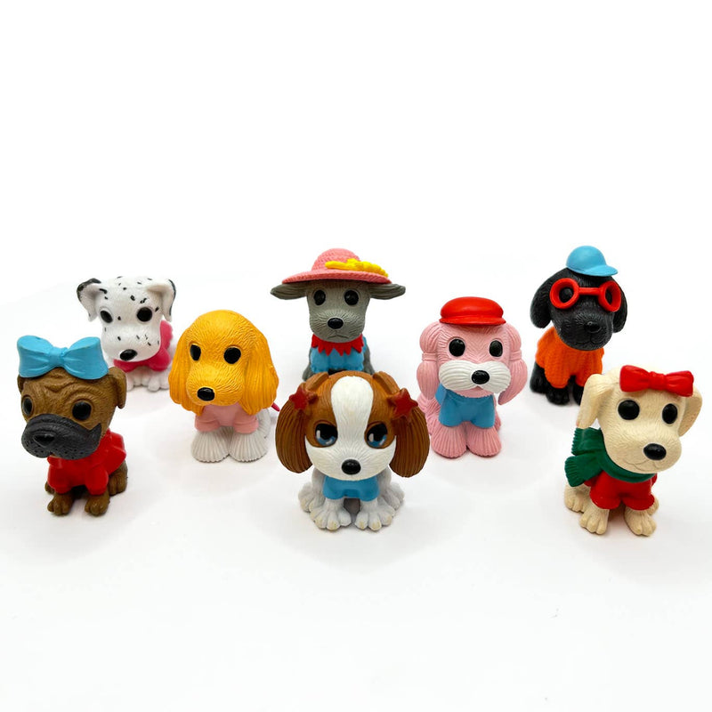 Collection of colorful cartoon dog figurines with various outfits and accessories on white background
