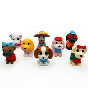 Collection of colorful cartoon dog figurines with various outfits and accessories on white background