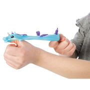 Child's hands holding blue unicorn flinger toy with purple mane and horn