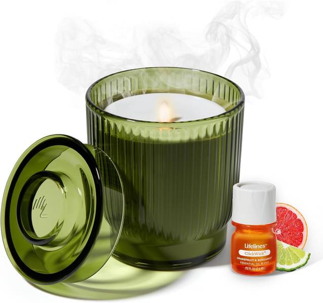 Green ribbed glass candle with lid and essential oil bottle on white background