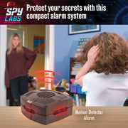 Spy Labs motion detector alarm system shown in home setting with child using device
