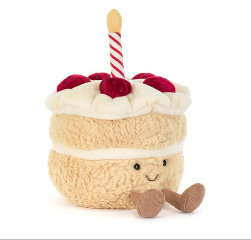 Jellycat Amuseables Birthday Cake plush toy with smiling face, striped candle, and red berries
