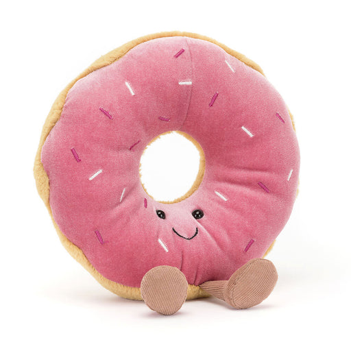 Pink frosted donut plush toy with smiling face and corduroy legs on white background