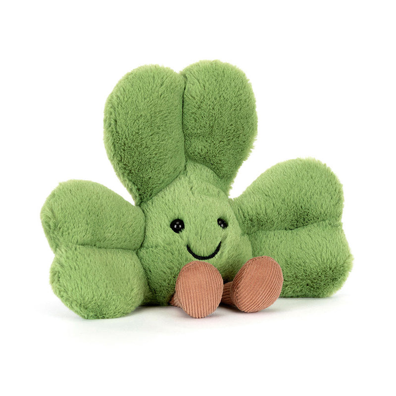 Green plush shamrock toy with smiling face and coral corduroy feet