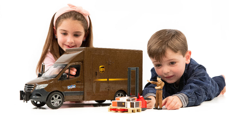 Two children playing with Bruder Mercedes-Benz Sprinter UPS toy truck with pallet jack and figurine