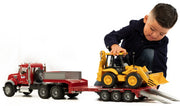 Boy playing with Bruder MACK Granite red truck low loader and yellow JCB backhoe loader toy set