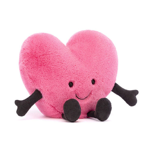 Pink heart-shaped plush toy with black arms, legs, and smiling face