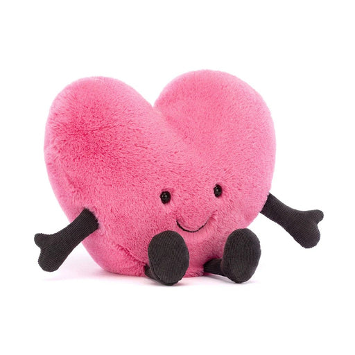 Pink heart-shaped plush toy with black arms, legs and smiling face