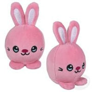 Two pink plush bunny toys with cute faces and upright ears on white background