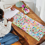 Child using eeBoo Learn to Draw Magical Creatures sticker activity set at wooden desk