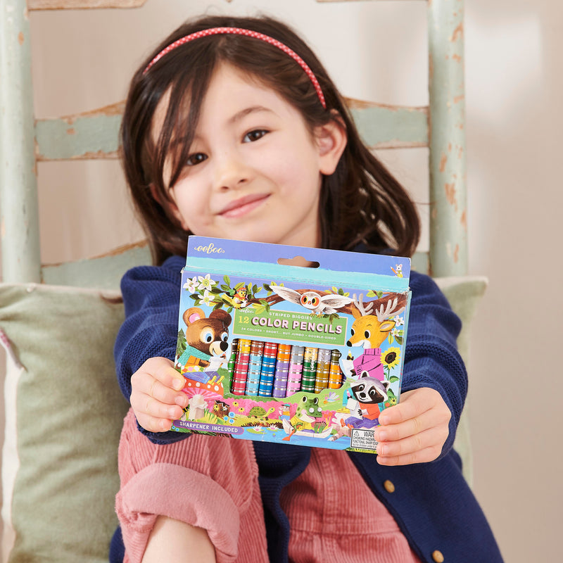 Child holding eeBoo striped colored pencils set with woodland animal characters packaging