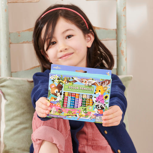 Child holding eeBoo striped colored pencils set with woodland animal characters packaging