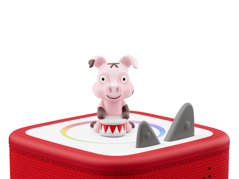 Pink pig Tonie figure on red Toniebox speaker with white background