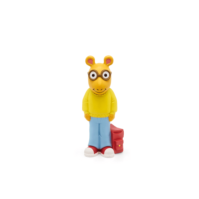 Arthur Tonie figure with yellow sweater, blue jeans, glasses and red backpack on white background