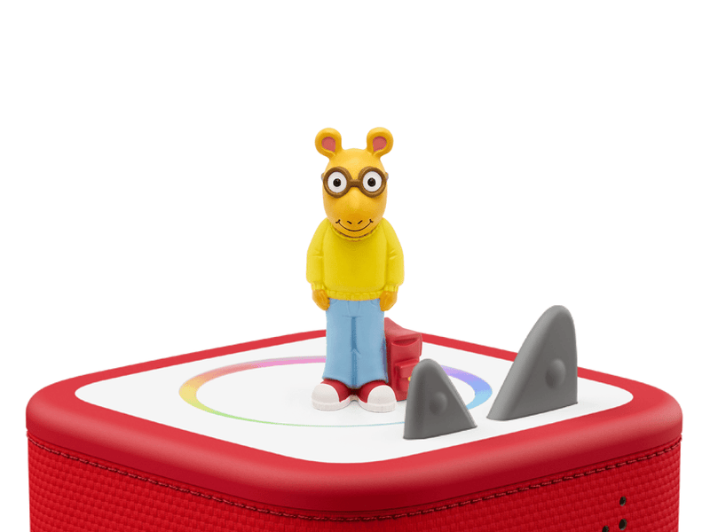 Arthur Tonie figure with glasses and yellow sweater on red Toniebox with shark fins